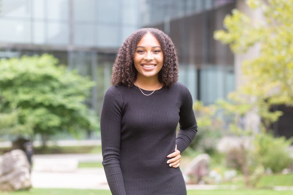 Outdoor photo of woman smiling into the camera.