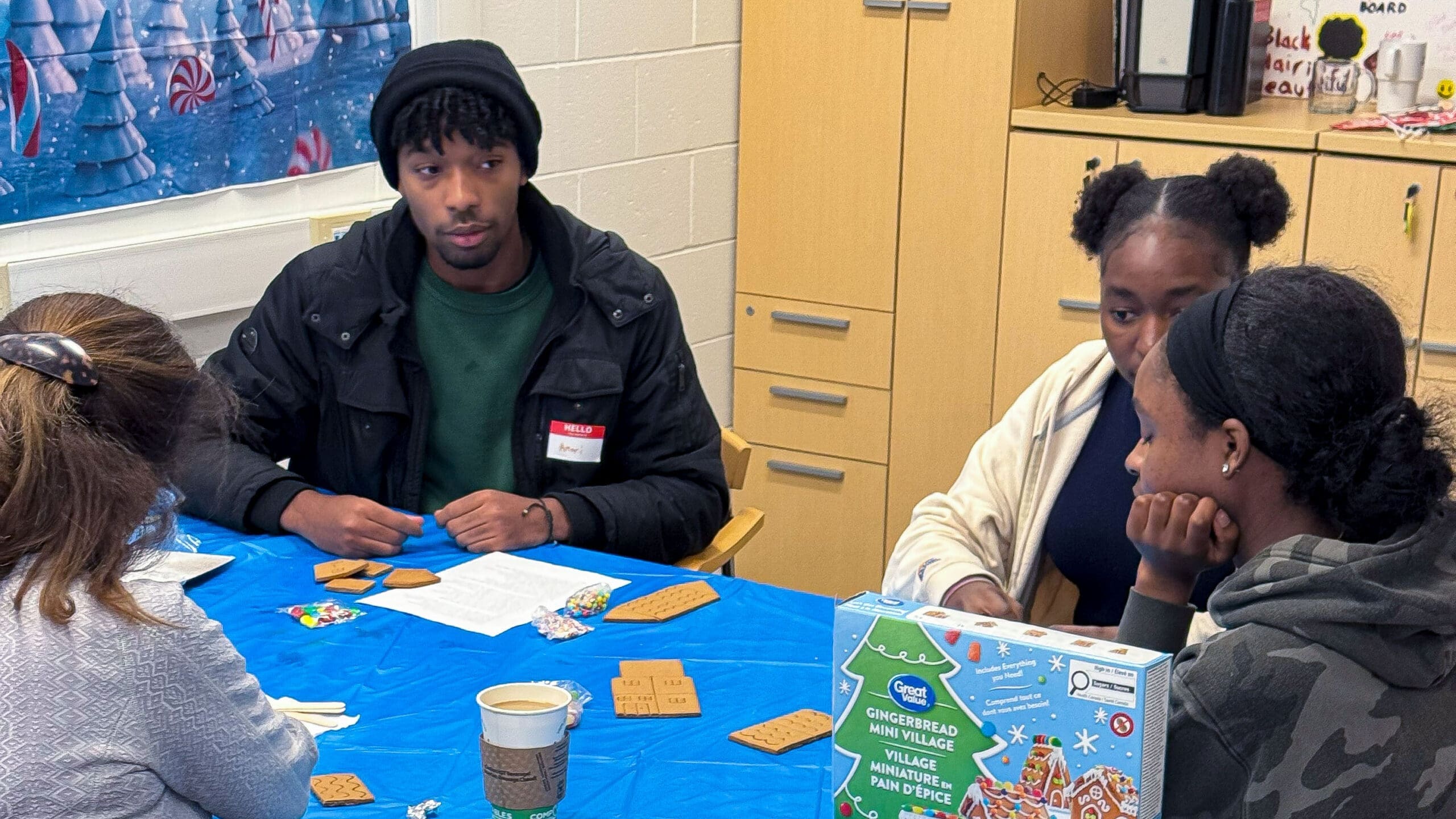 A group of students sitting in the CBEB decorating cookies