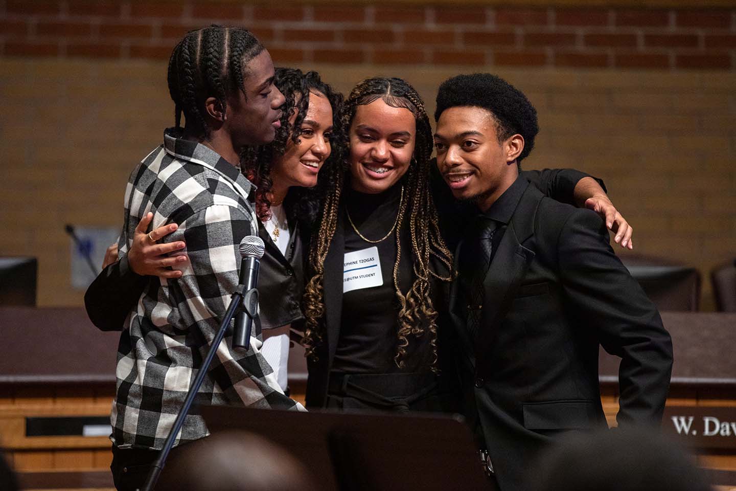 Four students hug during the SEE @ UTM celebration and graduation at the H.J.A. Brown Education Centre in Mississauga